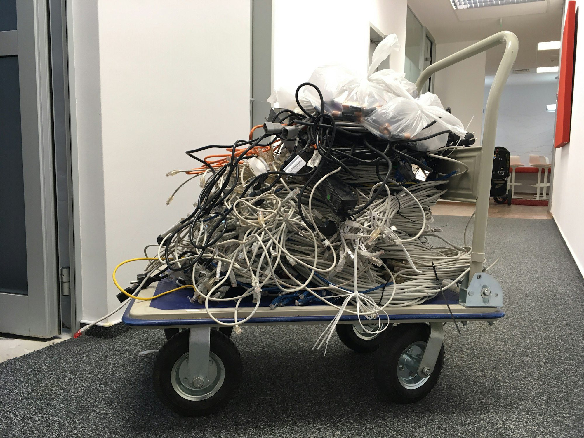 Cart with pile of used internet wires. Recycling electronics